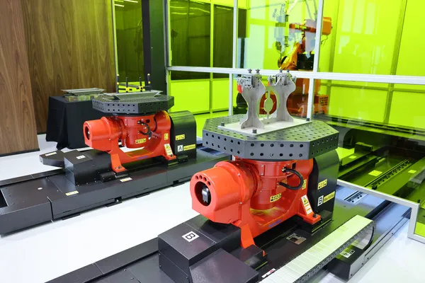 Dual rotary positioners with welded assemblies on fixture tables