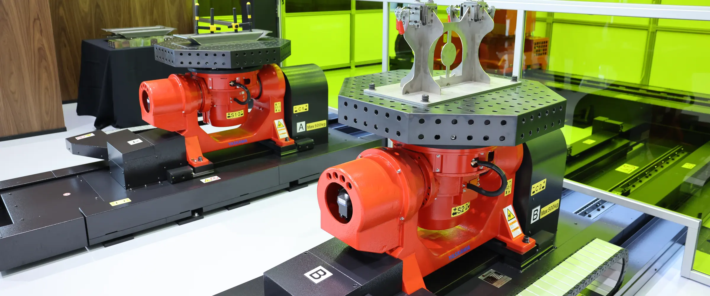 Dual rotary positioners with welded assemblies on fixture tables inside the laser-safe enclosure